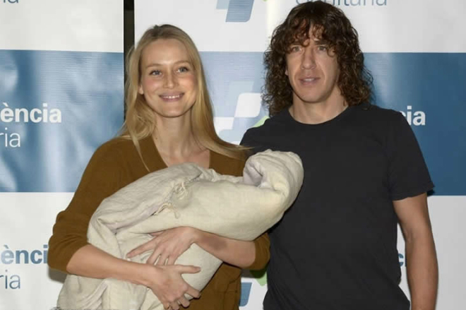 Carles Puyol with his wife and a child