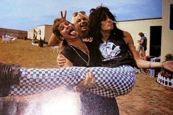 Ozzy Osbourne holding Tommy Lee in his arms
