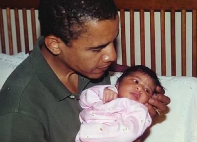 Barack Obama holding his newborn, first-born, Malia