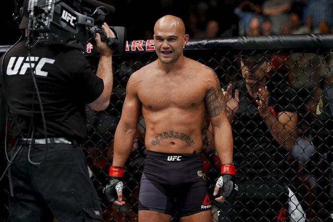 Robbie Lawler is posing in front of a camera in the ring