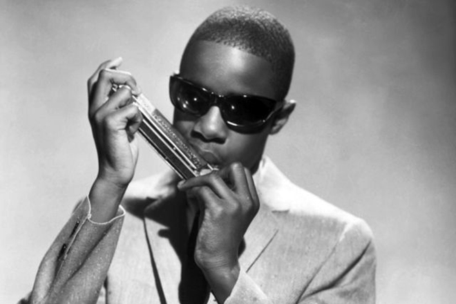 Young Stevie Wonder playing harmonica