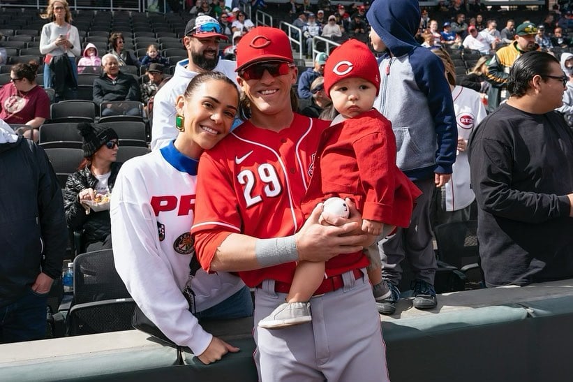 TJ Friedl with his wife and son