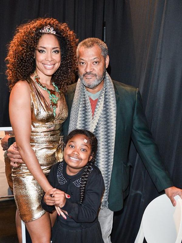 Gina Torres and Lawrence Fishburne with her daughter